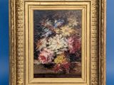 painting of flowers in a gold frame on a blue background