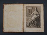 an old book with a drawing of a woman sitting on a chair