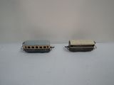 two small toy trains on a white surface