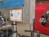 a picture of a man working on a machine in a garage