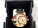 a watch in a black box on a white surface