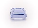 a close up of a blue sapphire stone on a white surface