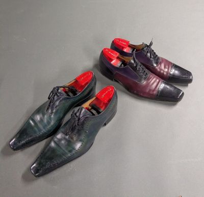 three pairs of men ' s shoes are lined up on a table
