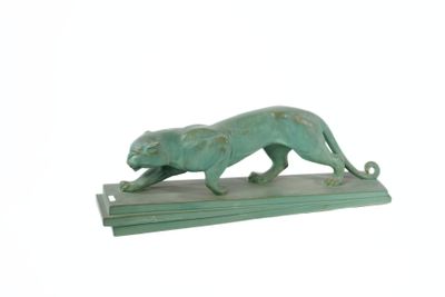 statue of a cat on a wooden base on a white background