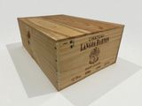 a wooden box with a label on it on a white surface