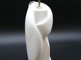 a white vase with a small light on top of it