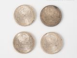 four different types of coins are shown on a white surface