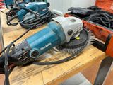 several electric tools are sitting on a wooden table in a workshop