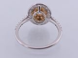 a close up of a ring with a yellow diamond in it