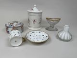 many different types of porcelain items on the table
