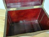a small wooden chest on a wooden floor