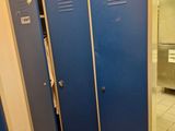 two blue lockers next to each other in a bathroom