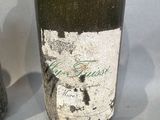 a bottle of wine sitting next to a bottle of wine on a table