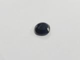 a close up of a black diamond on a white surface