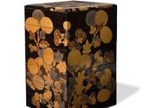 an image of a black and gold box with flowers and leaves on it