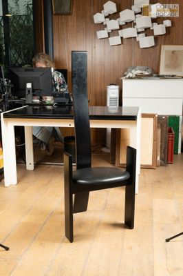 un homme assis à un bureau, avec un ordinateur portable devant lui