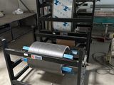 a machine that has a roll of paper on it