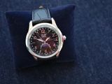 a watch that is sitting on top of a blue pillow