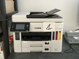 a printer sitting on top of a desk next to a printer