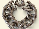 silver chain bracelet on a white background with a flower in the center