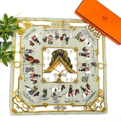 a square scarf with a picture of a man and a woman on horseback