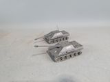 three toy tanks that are sitting on the ground