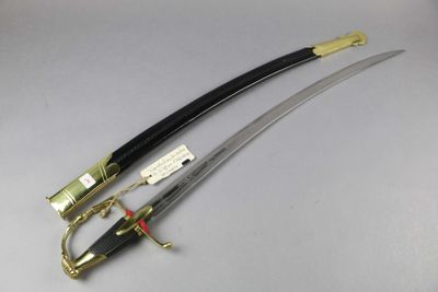 two swords with a gold handle and a black handle