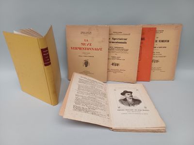 several old books sitting on top of a table next to each other