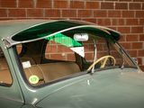 a green car with a sticker on the side of it
