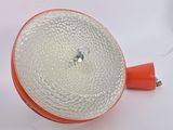 an orange light that is on a white table