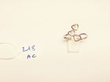 a small ring with a heart on it next to a smaller ring with a heart on it