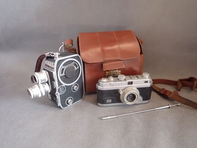 a camera and a bag on a table next to each other