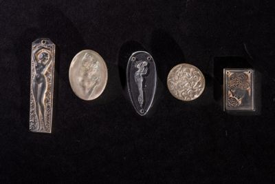five different types of silver and silver jewelry on a black surface