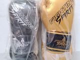 two boxing gloves are wrapped in plastic on a white surface