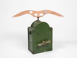 a small green clock with a bird on top of it