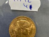 a gold coin in a plastic bag with a label on it
