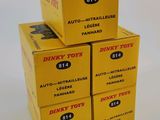 four boxes of dinky toys are stacked on top of each other