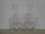 three clear wine glasses sitting on top of each other on a table