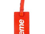 an orange luggage tag with the word eme on it