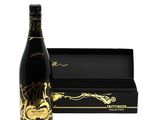 the bottle of champagne is next to a black box
