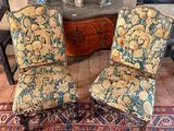 two chairs sitting next to each other on a rug
