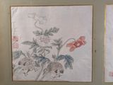 two paintings of flowers on the wall of a room