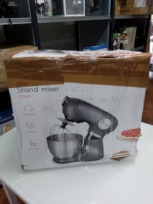 packaging of a stand mixer sitting on a table in a room