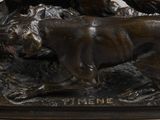 bronze statue of a dog and a cat on a rock