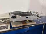 a record player sitting on top of a metal shelf