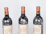 three bottles of wine sitting next to each other on top of a table
