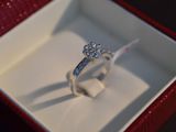 a diamond ring sitting in a red box on a table