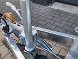 a dolly with a handle attached to it on the sidewalk