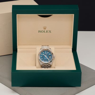 the rolex watch is in the box on the table