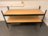 a wooden table with two shelves on top of it in a room